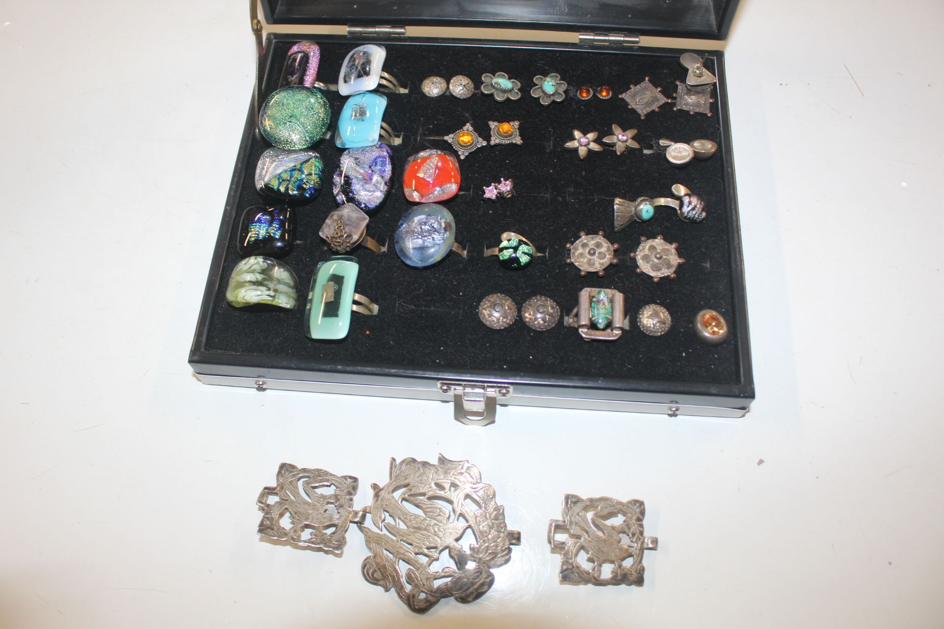 A display box and contents of various white metal