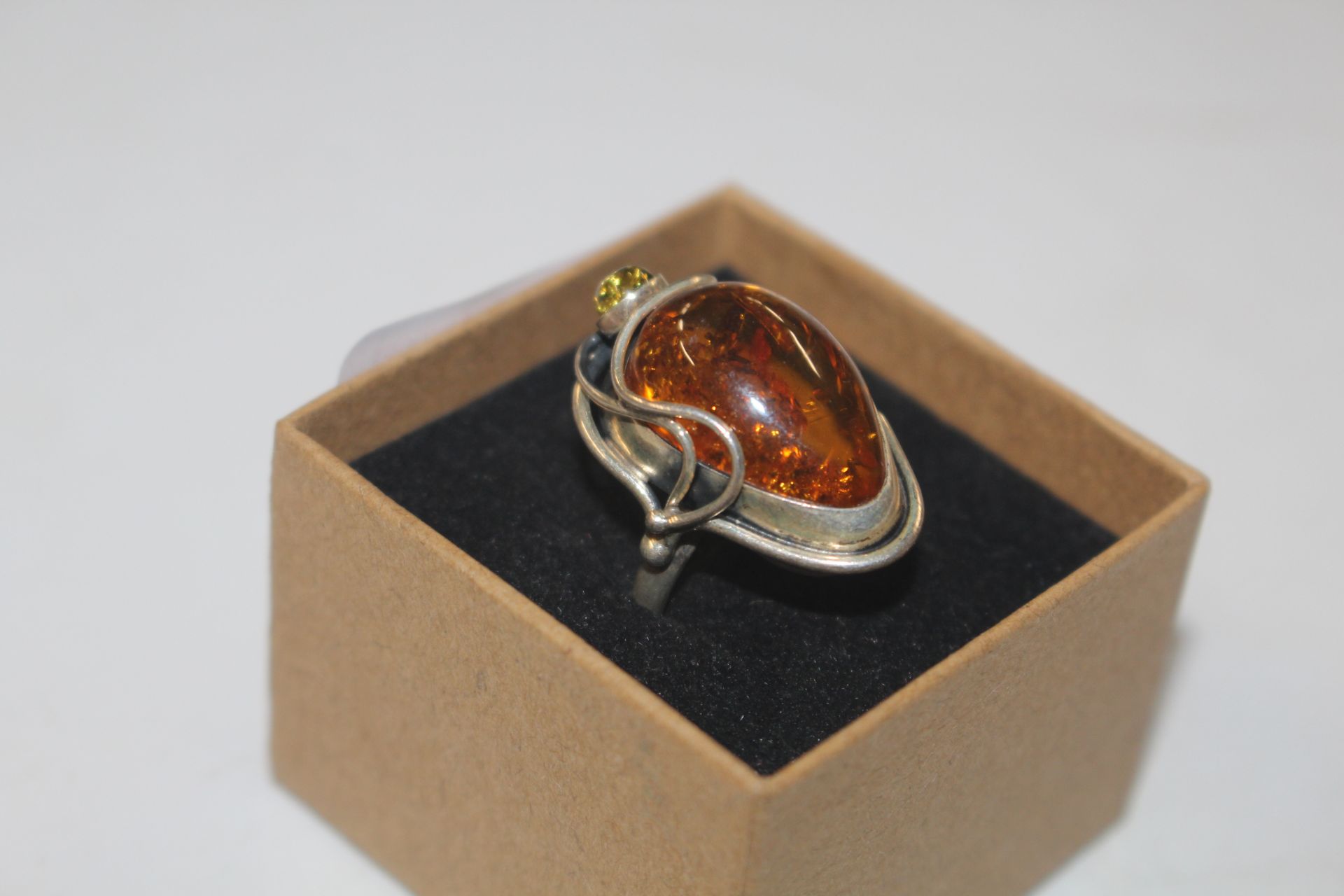 An Art Nouveau style Sterling silver amber set rin