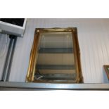 A gilt framed bevel edge wall mirror