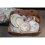 A box of various patterned dinnerware and ornament