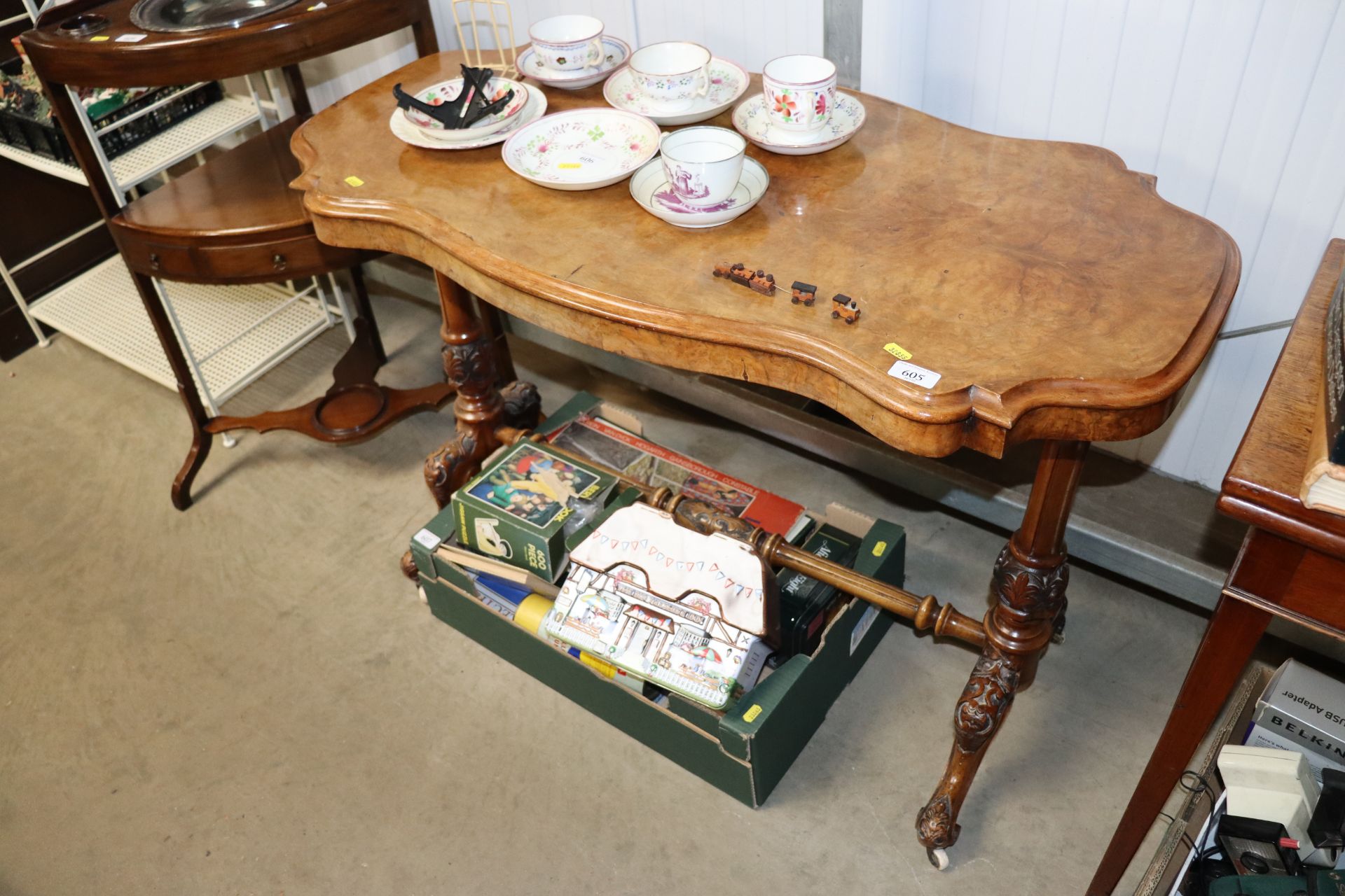 A late Victorian carved walnut table raised on str