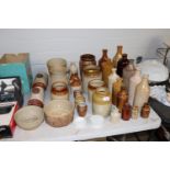 A collection of various stoneware bottles, jars an