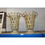 A pair of metal urns