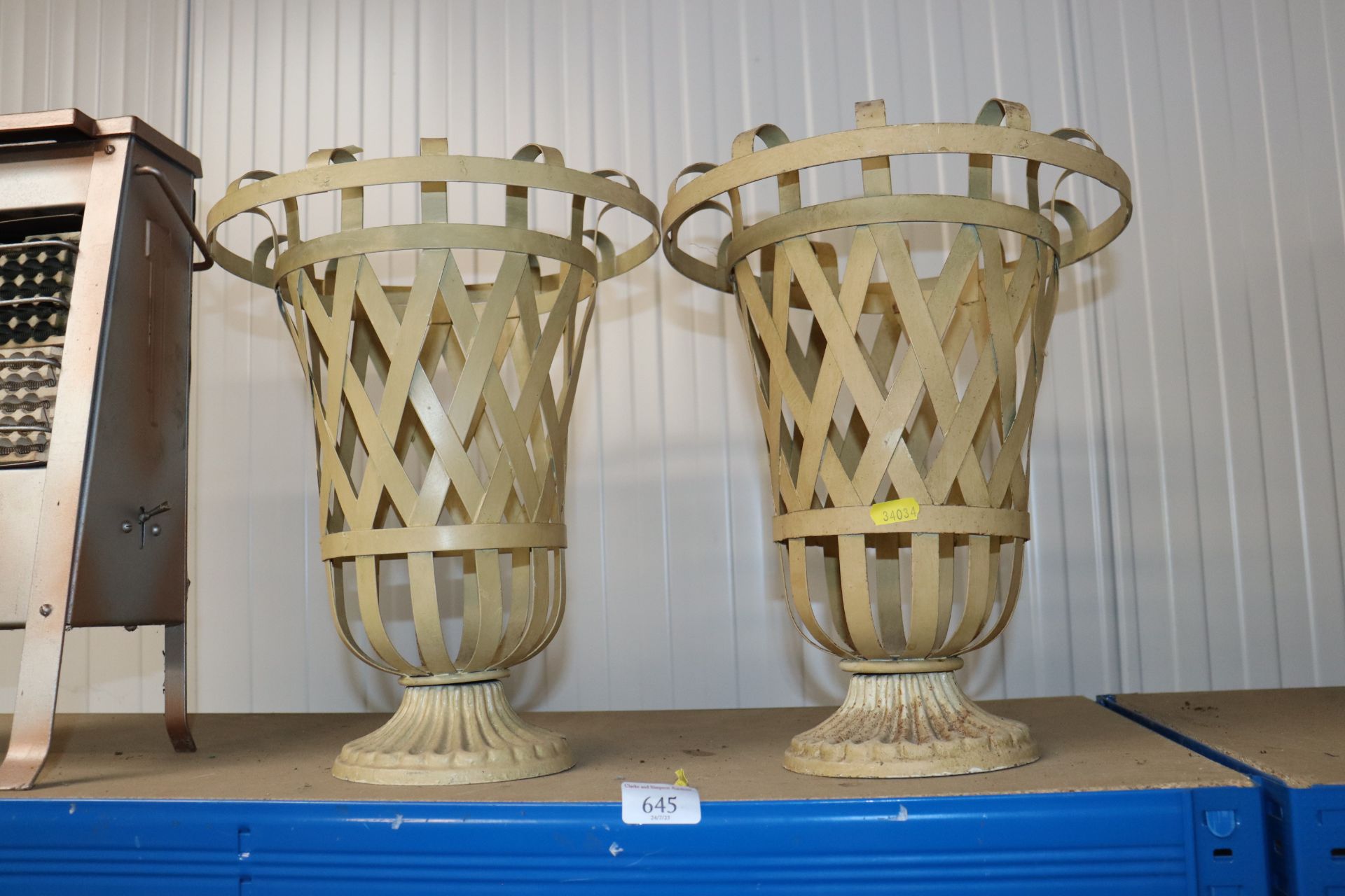 A pair of metal urns