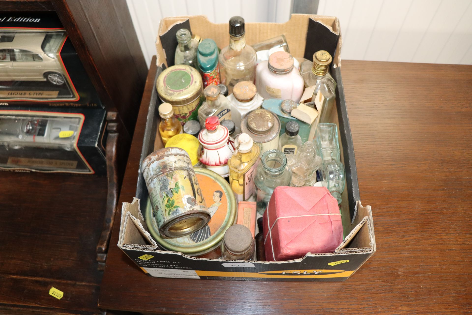 A box containing advertising bottles and tins
