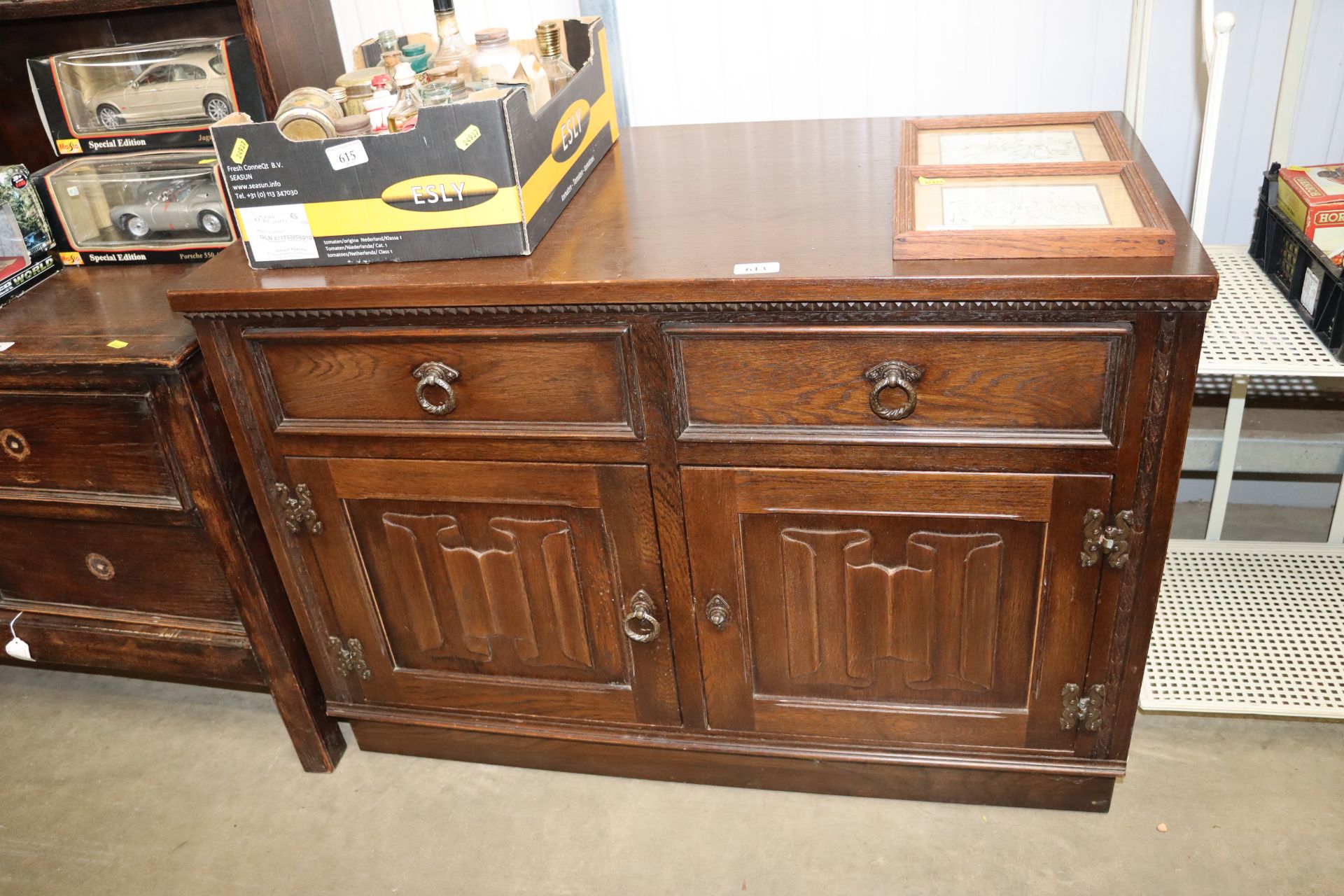 A JayCee oak linen fold decorated cupboard fitted