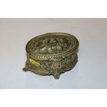 An oval brass trinket box