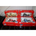 Four boxed diecast models of motorbikes