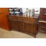 An oak linenfold decorated sideboard fitted three