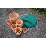 A quantity of various sized terracotta plant pots