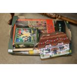 A box of games and advertising tins