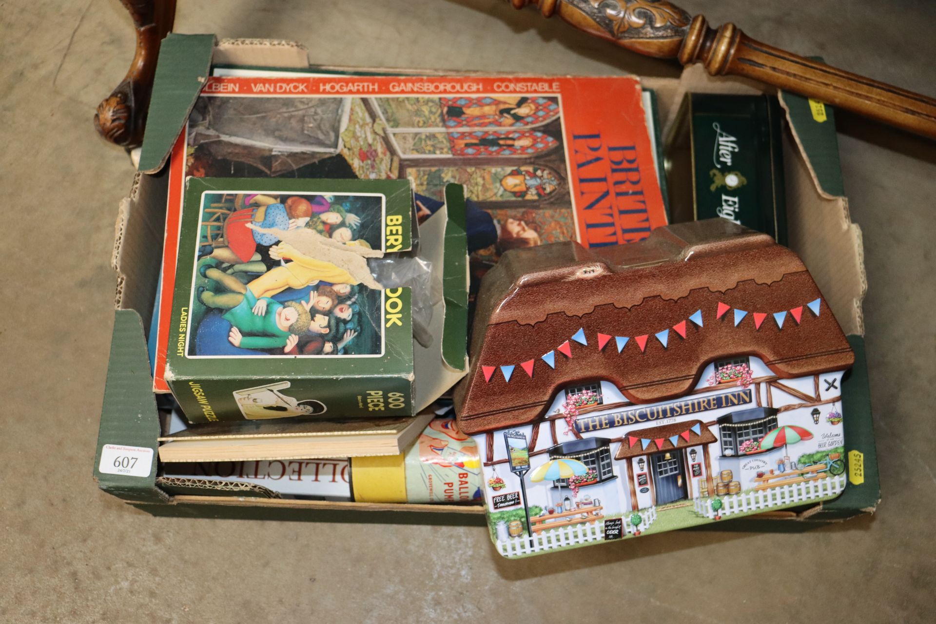 A box of games and advertising tins