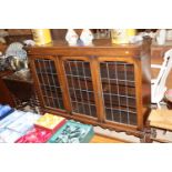 A 1930's oak and leaded glazed bookcase, two door