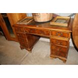 A reproduction yew wood finish pedestal writing de