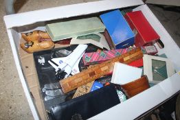 A box containing wooden rulers; various cutlery, t