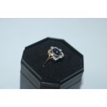 A yellow metal cabochon sapphire and diamond set r