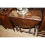 An oak barleytwist gate leg dining table and a set