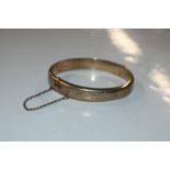 A 9ct gold snap bangle, approx. 13.5gms