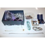 A box of assorted costume jewellery including ear-