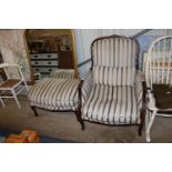 A deep seated armchair and footstool in striped up