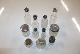 A collection of silver topped jars etc.