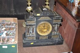 A late Victorian black slate two hole mantel clock