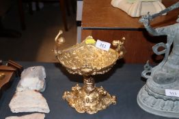 A gilt bronzed pedestal salt with cherub decoratio