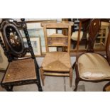 An antique chapel chair with rush seat