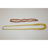 An amber coloured bead necklace; and a butterscotc