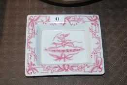 A white and pink glazed dish, decorated with a che