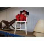 A child's commode chair and a Paddington bear