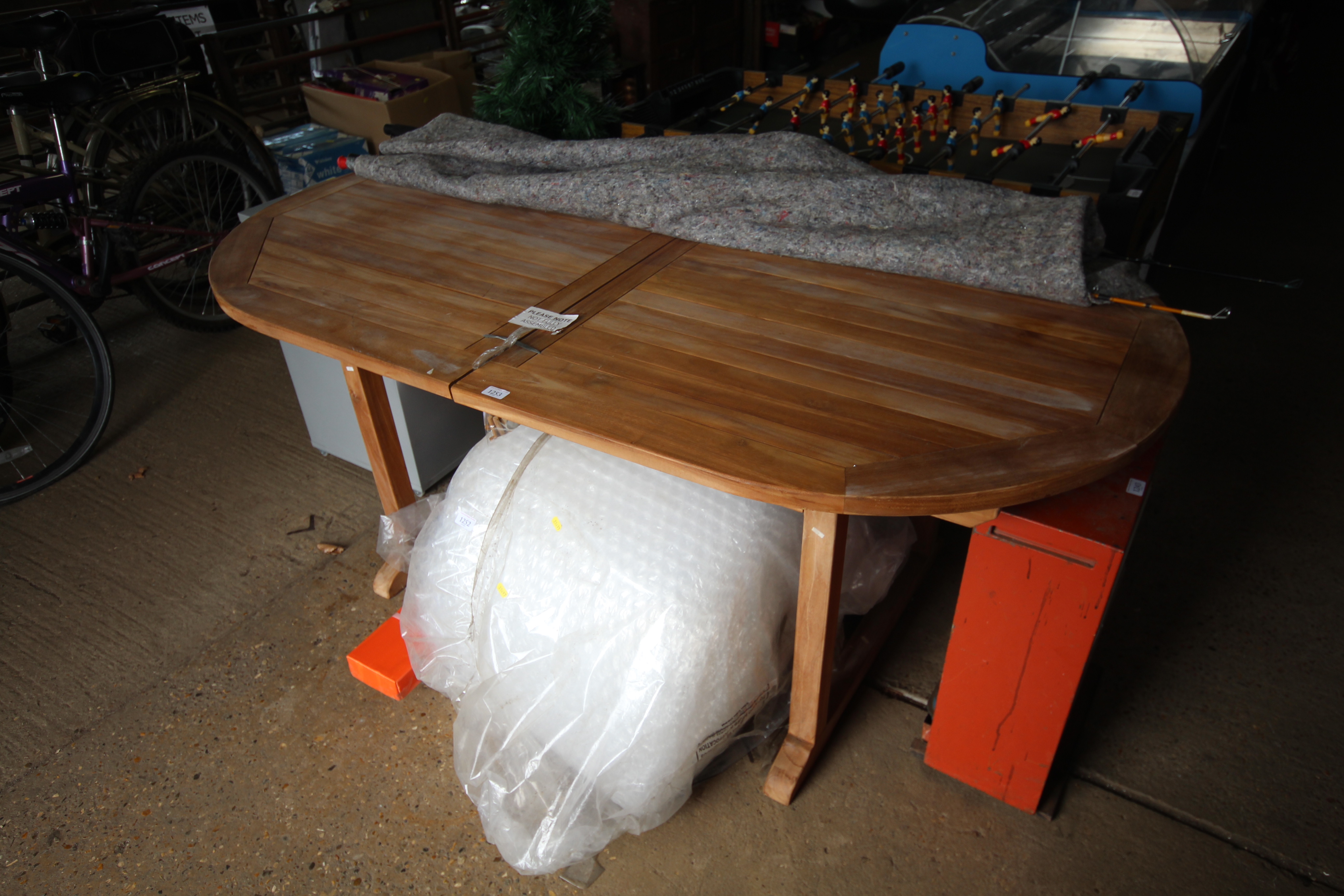 An eight seater Indonesian hardwood garden table