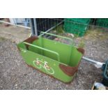 A green painted metal planter/bicycle rack