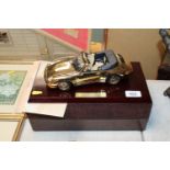 A 22ct gold plated scale model of a Porsche 911 Ca