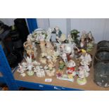 A collection of figurines and figural decorated va