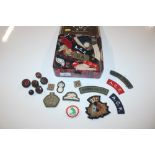 A tin of mixed military cloth badges