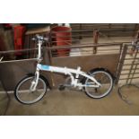 A TERN Link C7 folding bicycle lacking seat with front and rear mudguards with 7 speed gears