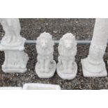 A pair of cast concrete statues in the form of sma