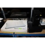 A Nintendo Wii Fit Board and four Panasonic speake