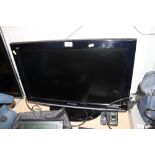 A Panasonic flat screen television with remote con
