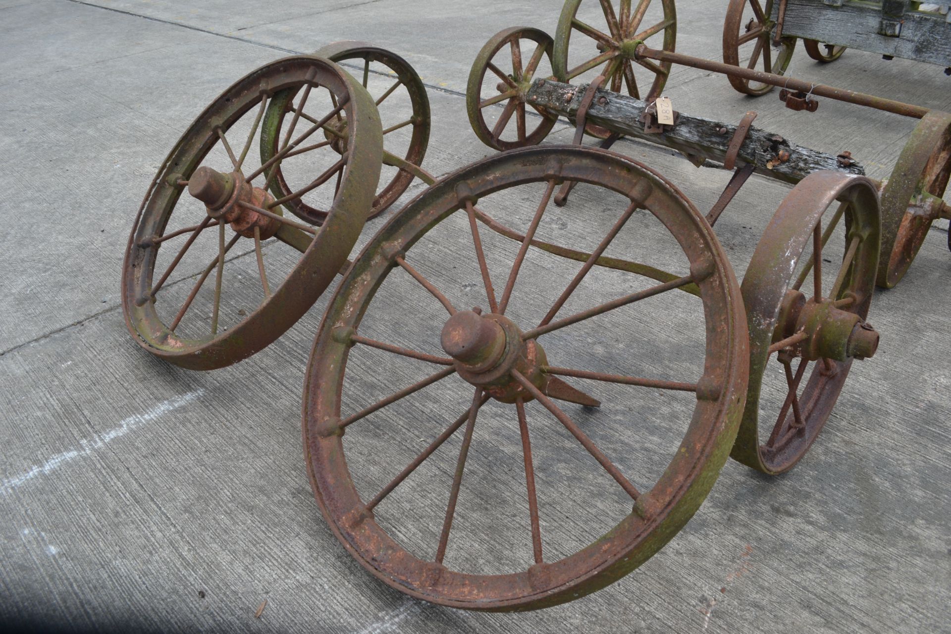 Set of four matching cast wheels on axles. Suit shepherds hut.