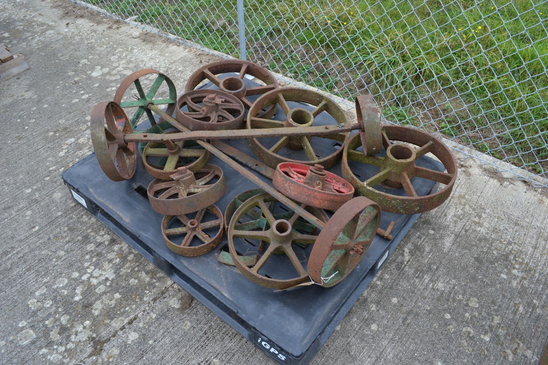 Pallet of various cast iron wheels.