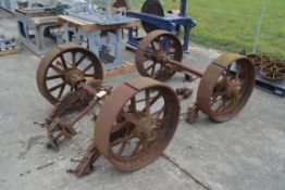 Set of four matching cast iron Foster of Lincoln steam traction wagon wheels. With axles and leaf