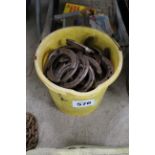 Bucket of used horse shoes.