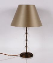 A modern design glass and brass table lamp, having