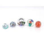 Six various coloured glass paperweights