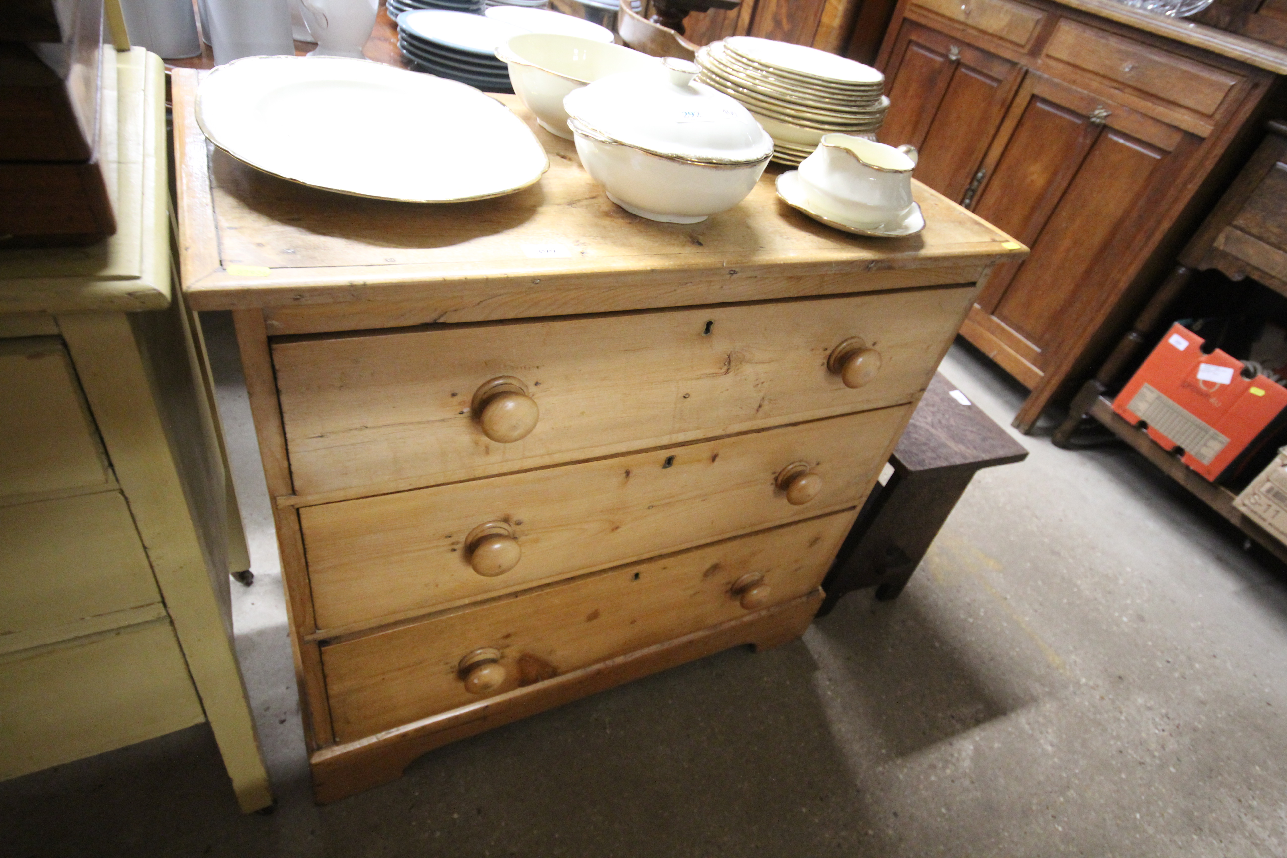 A striped pine chest of three long drawers