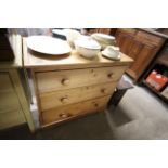 A striped pine chest of three long drawers