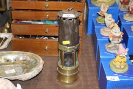 A vintage brass and metal miners lamp