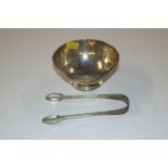 A silver bowl Birmingham 1929; and a pair of sugar tongs, total weight 141gms